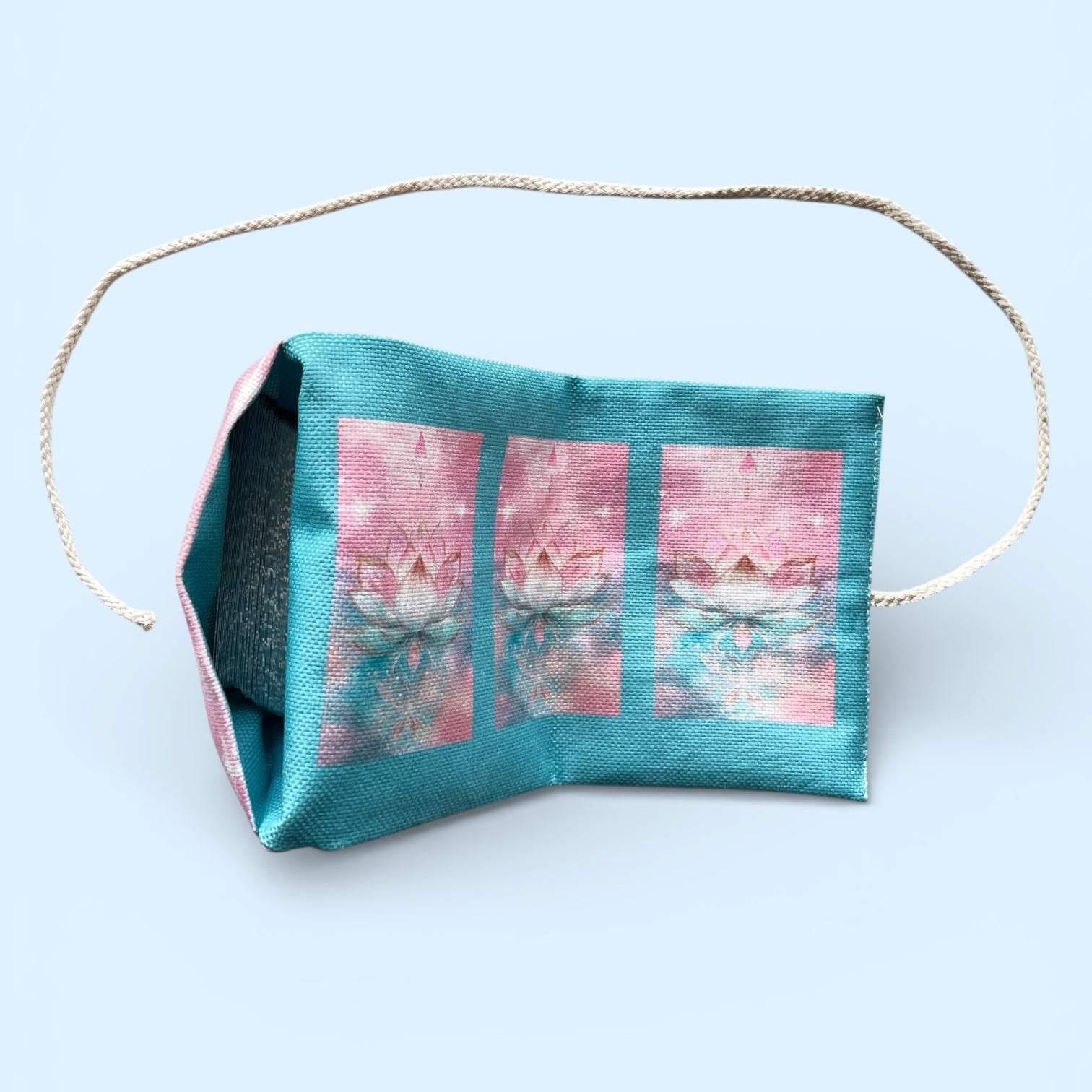 Fabric face mask with a pink floral design on a light blue background